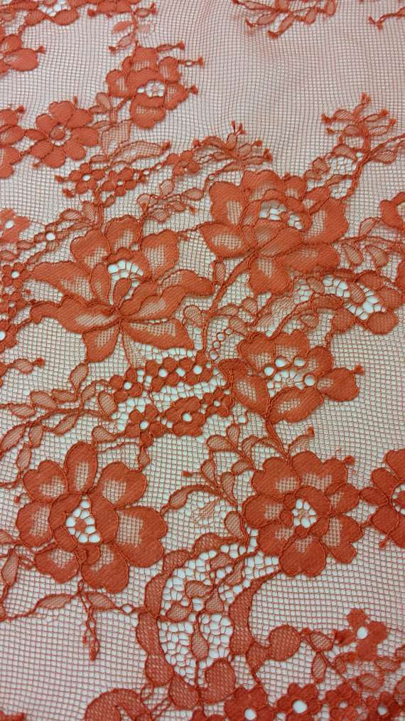 Delicate red orange lace fabric