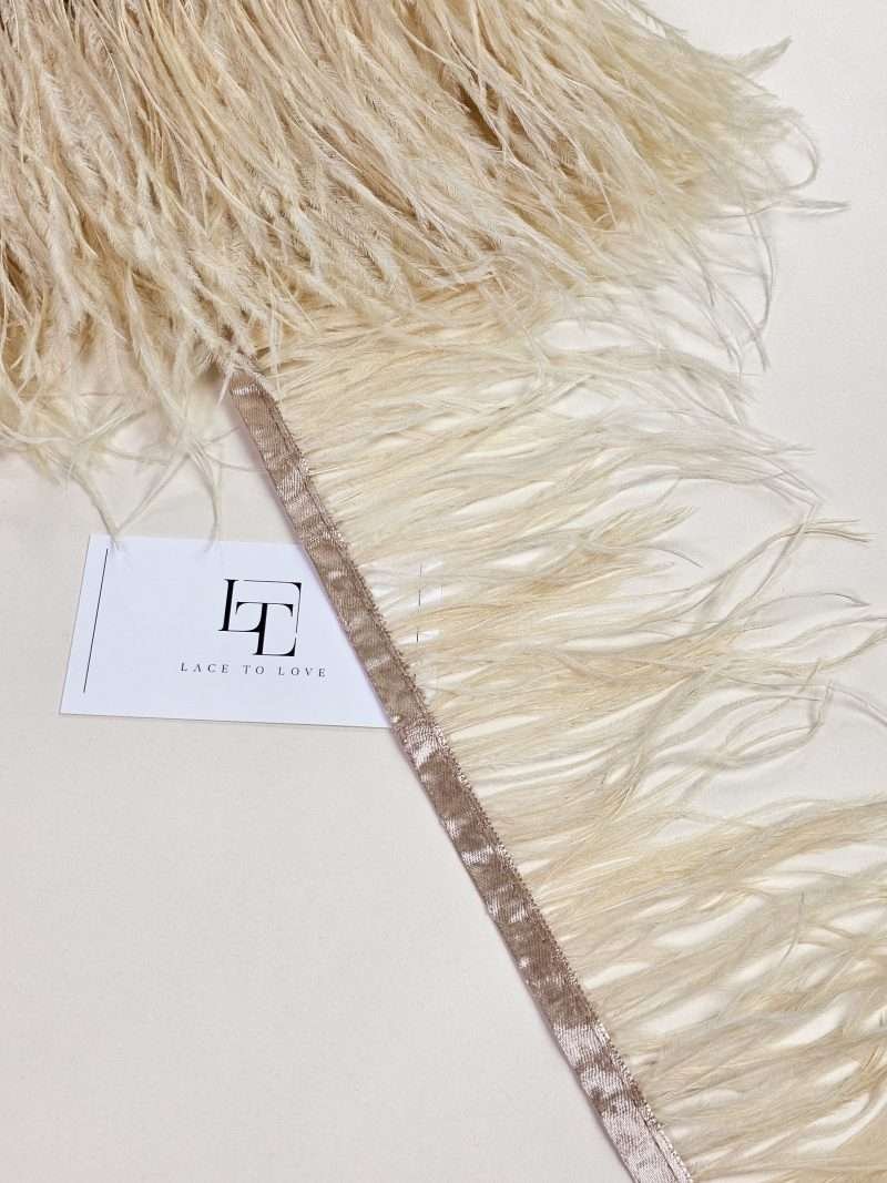 Light beige ostrich feather fringe on a ribbon