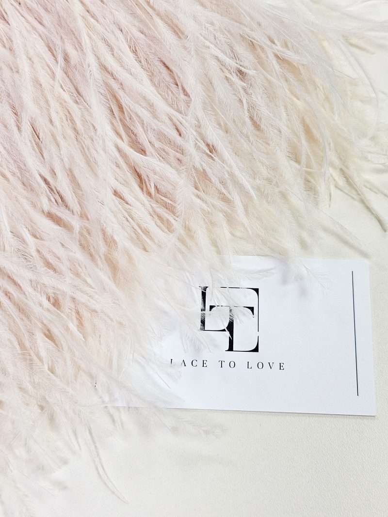 Light pink ostrich feather fringe on a ribbon