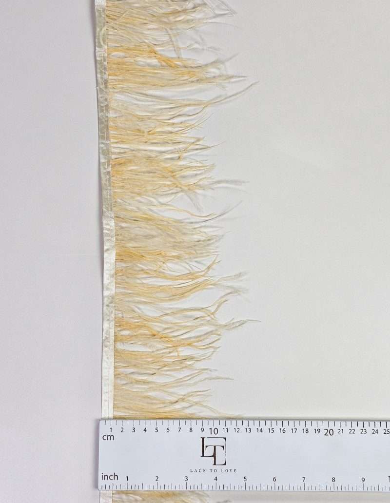 Pale yellow ostrich feather fringe on a ribbon
