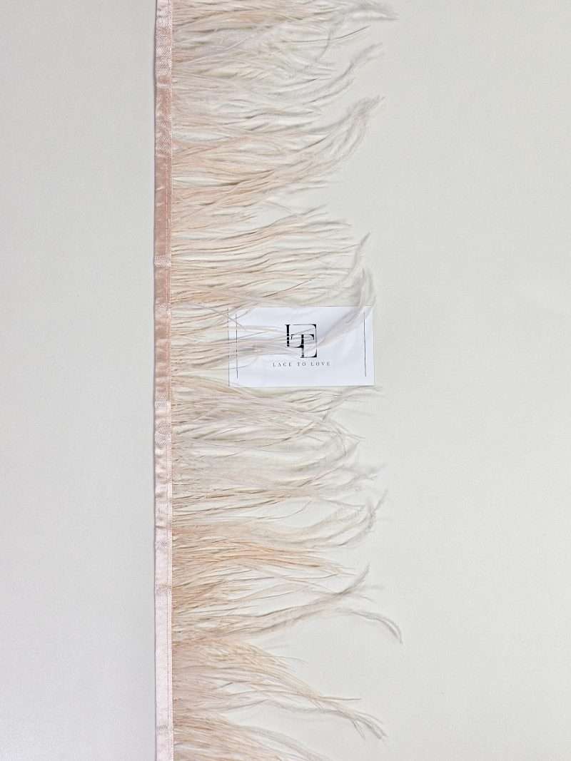 Salmon pink ostrich feather fringe on a ribbon
