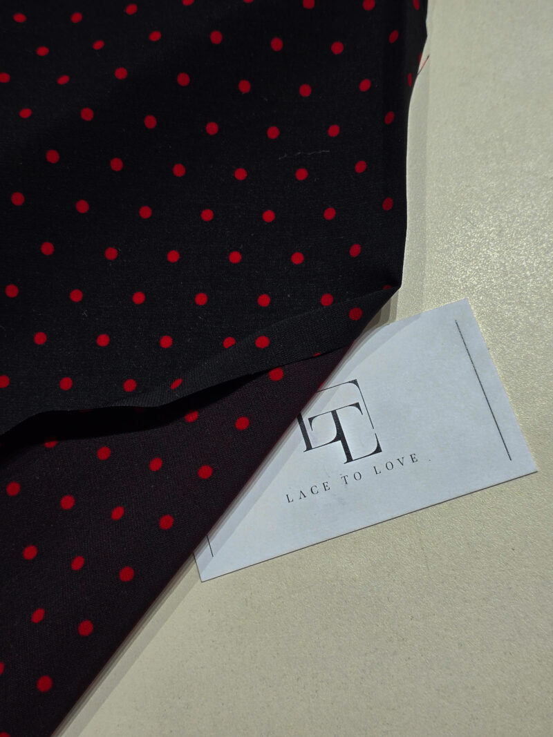 Black delicate crepe fabric with red polka dots