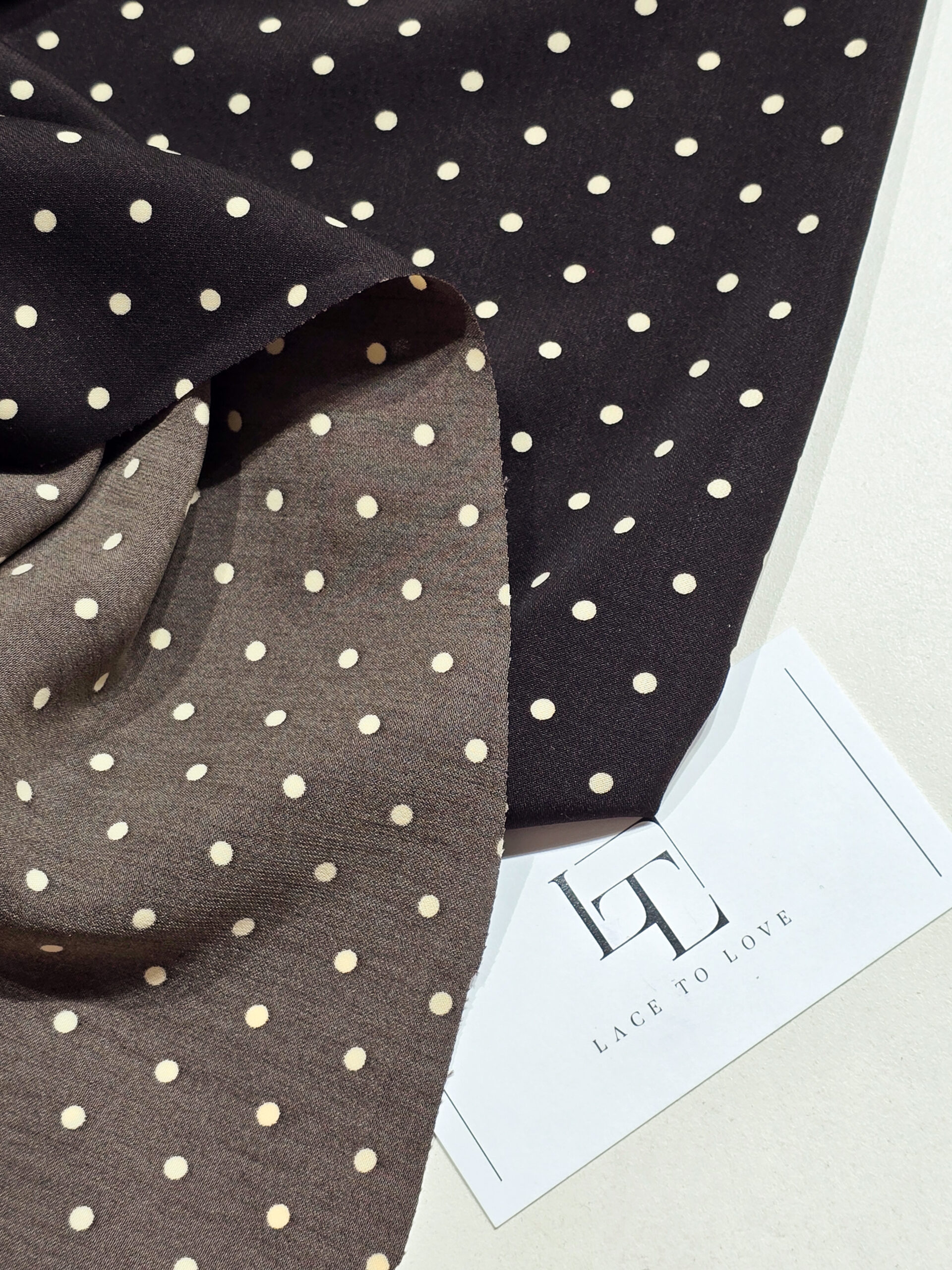 Brown delicate crepe fabric with white polka dots