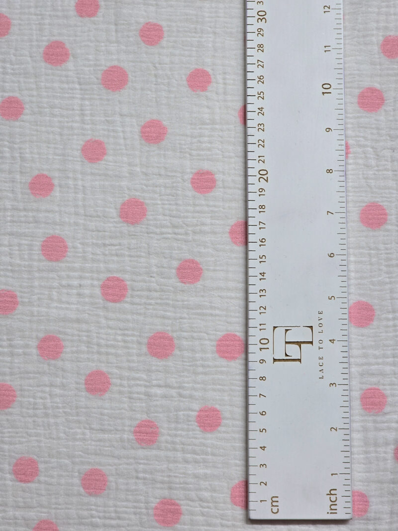 White muslin fabric with pink polka dots