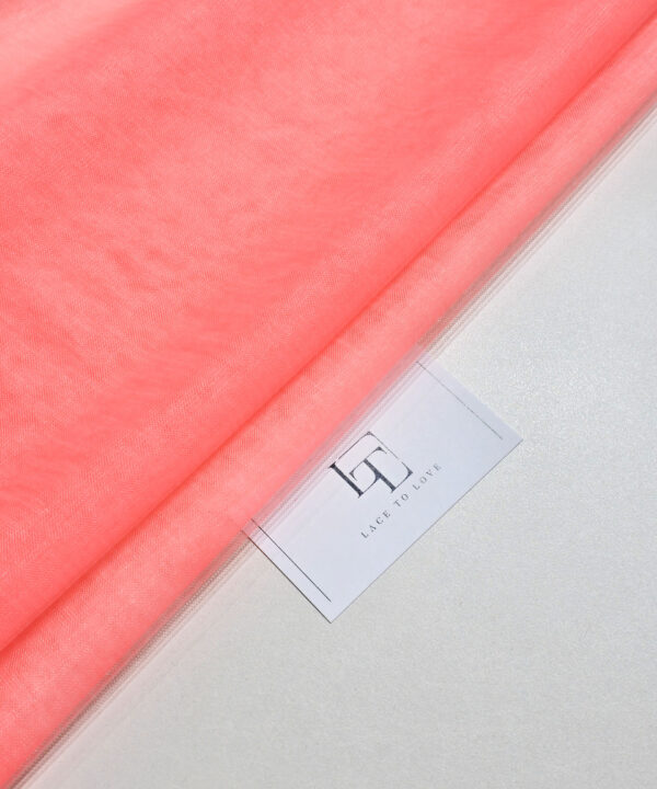 Neon salmon pink soft well draping delicate tulle fabric